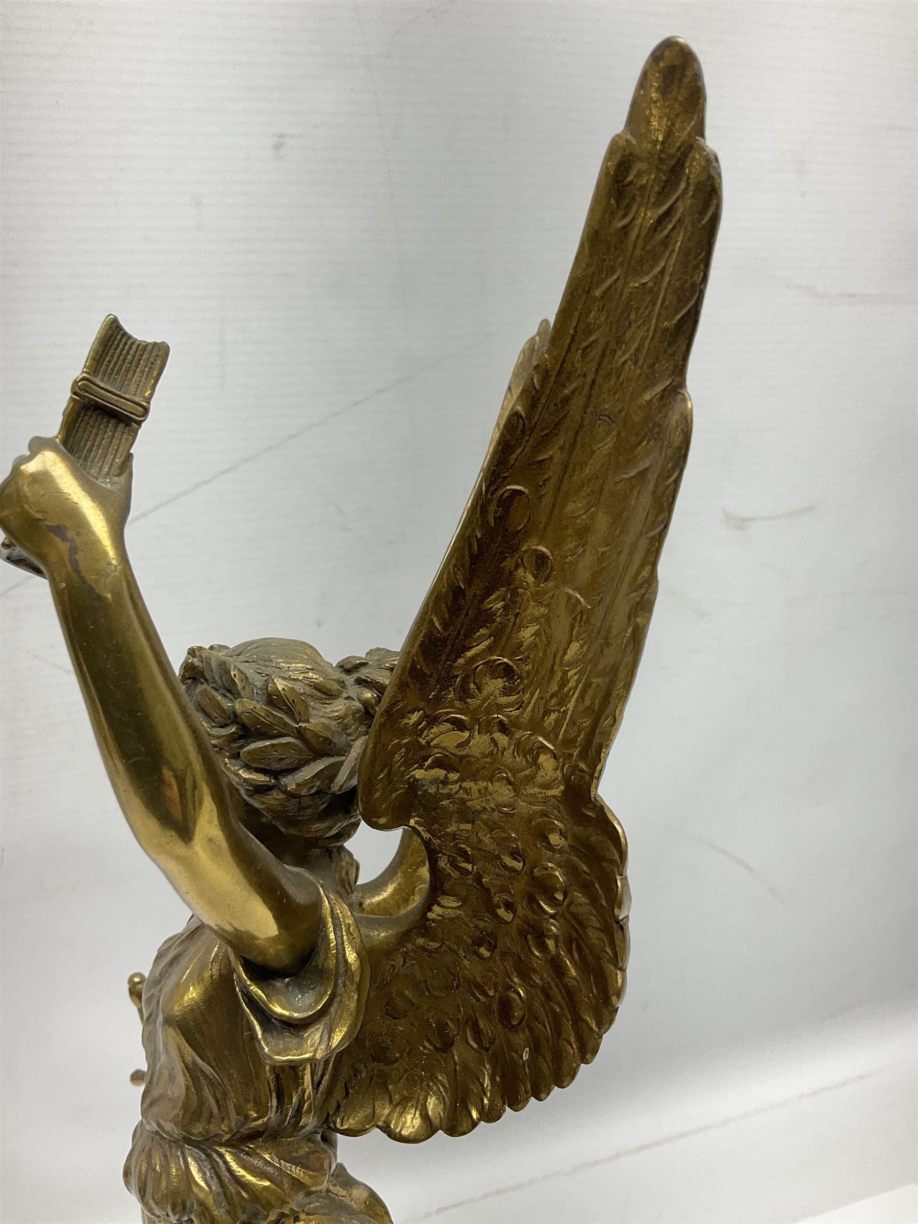 After Oswald Schimmelpfennig (German, 1872-1939): Pair of gilt bronze winged Allegorical female figures, the first example with arm outstretched holding a branch, signed 'Schimmelpfennig 1900', the second with arm raised above her head holding a book and sword in the other, both raised upon marble plinths, H45cm
