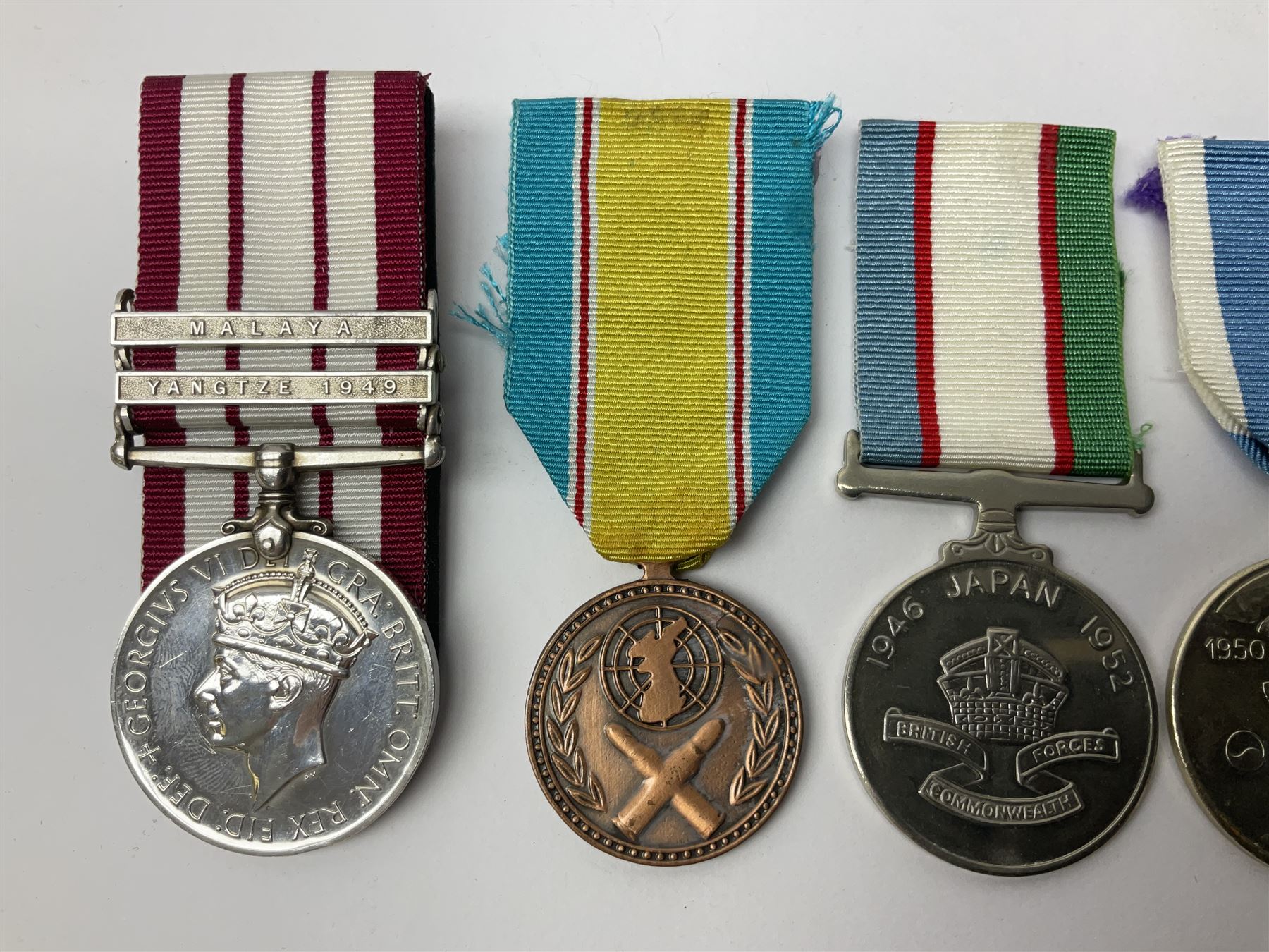 1949 Yangtze Incident HMS Consort casualty Naval General Service Medal with two clasps for Yangtze 1949 and Malaya awarded to D/SSX. 788562 J. Tootell A.B.R.N.; with four other medals comprising Republic of Korea War Service Medal, Eastern Service Medal, unofficial British and Commonwealth Occupation Forces Association Occupation of Japan medal and IFKVWA 40th Anniversary Medal; together with an archive of contemporary and later related items including Certificate of Service 1946-54, Recommendations for Advancement and Conduct Record Sheet 1946-53, Quartermasters History Sheet 1949-53, Destroyer Association China Station 1945-53 beret, later manuscript journal with his own account of the Yangtze incident etc, Joe's birth certificate details dated 1968, reprinted half-length portrait in uniform, Manual of Seamanship 1937, modern shield and framed crests, blazer badges and metal badges and a copy of Loyal & Steadfast - The Story of HMS Consort 2008, which gives details of how Joe Tootell received his wounds, the extract reads ' When Consort came under fire a short time later it was a strange, perhaps unreal experience for many of the crew who had never seen action before. Ordinary Seaman Joe Tootell was in the wheelhouse. 'I could not see the action. We could hear the ship taking severe punishment. When the wheelhouse took a direct hit, killing the coxwain, Chief Petty Officer Gurney, and myself receiving multiple shrapnel wounds, the steering mechanism was put out of action.'