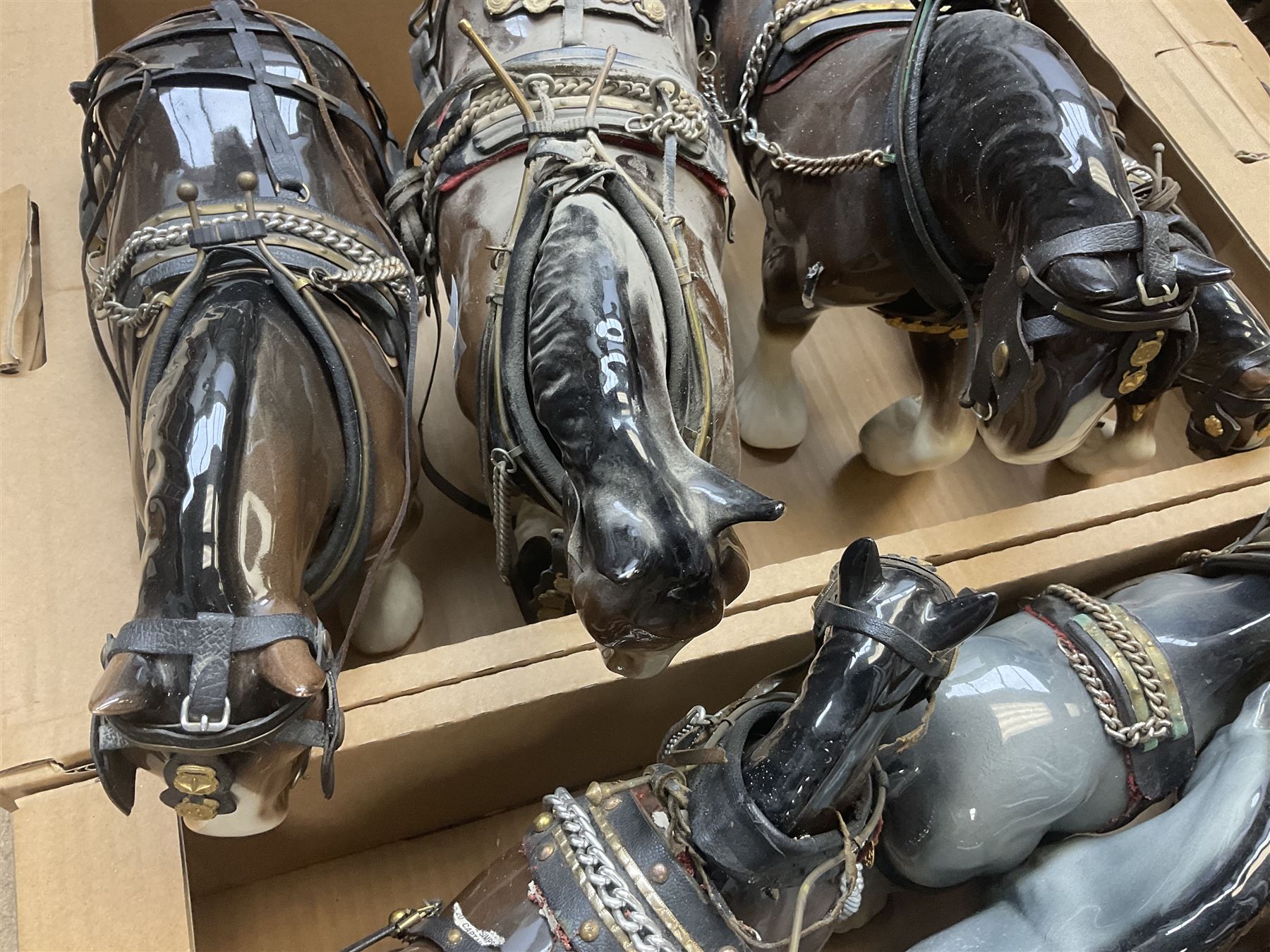 Approximately forty seven ceramic Shire horses to include Sylvac and Melba Ware examples of various sizes and colours, many with harnesses, and a quantity of carts and wagons 