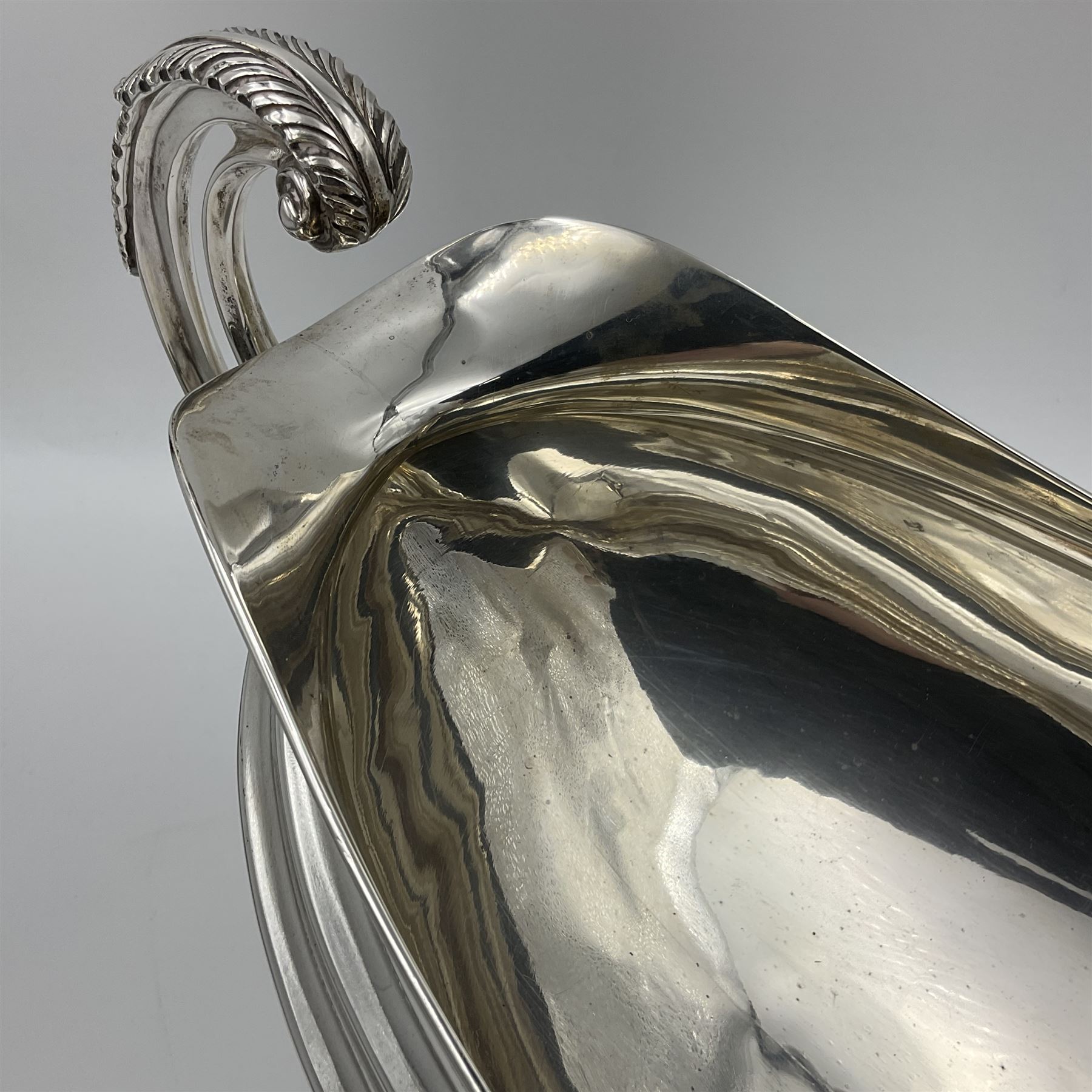 1920s silver twin-handled pedestal bowl, of navette form with twin bifurcated acanthus capped scroll handles, engraved with initial R to body and upon spreading oval foot, hallmarked Hawksworth, Eyre & Co Ltd, Sheffield 1925, including handles H21.8cm