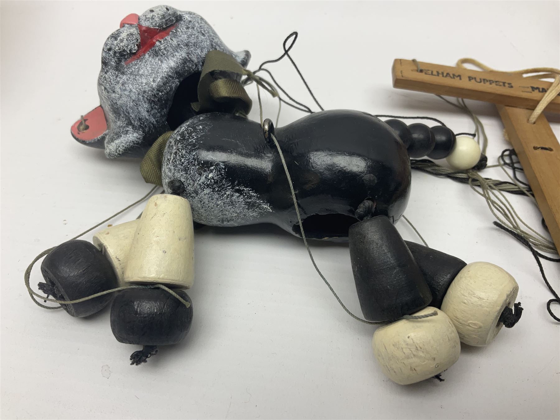 Pelham Puppet - three puppets comprising a painted wooden duck with felt mouth and wings with metal joints H12cm, in original box and instructions; and two further examples Type A cat with a hollow body H12cm, and a boy H23cm (3) 