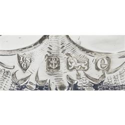 Edwardian silver dish ring in the Irish manner, of circular waisted form, embossed and pierced throughout with flower heads and foliate and C scrolls, hallmarked I S Greenberg & Co, Birmingham 1904, with accompanying blue glass liner, upper rim D17.5cm, approximate weight 6.84 ozt (213 grams)