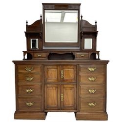 Edwardian mahogany dressing chest, raised triple mirror back with bevelled plates and fluted decoration over two trinket drawers, the base fitted with two central cupboards flanked by four graduating drawers to each side