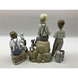 Three Lladro figures, comprising Guest of Honor no 5877, Boy with Boat no 5166 and Puppet Show no 5736, all with original boxes, largest example H22cm  