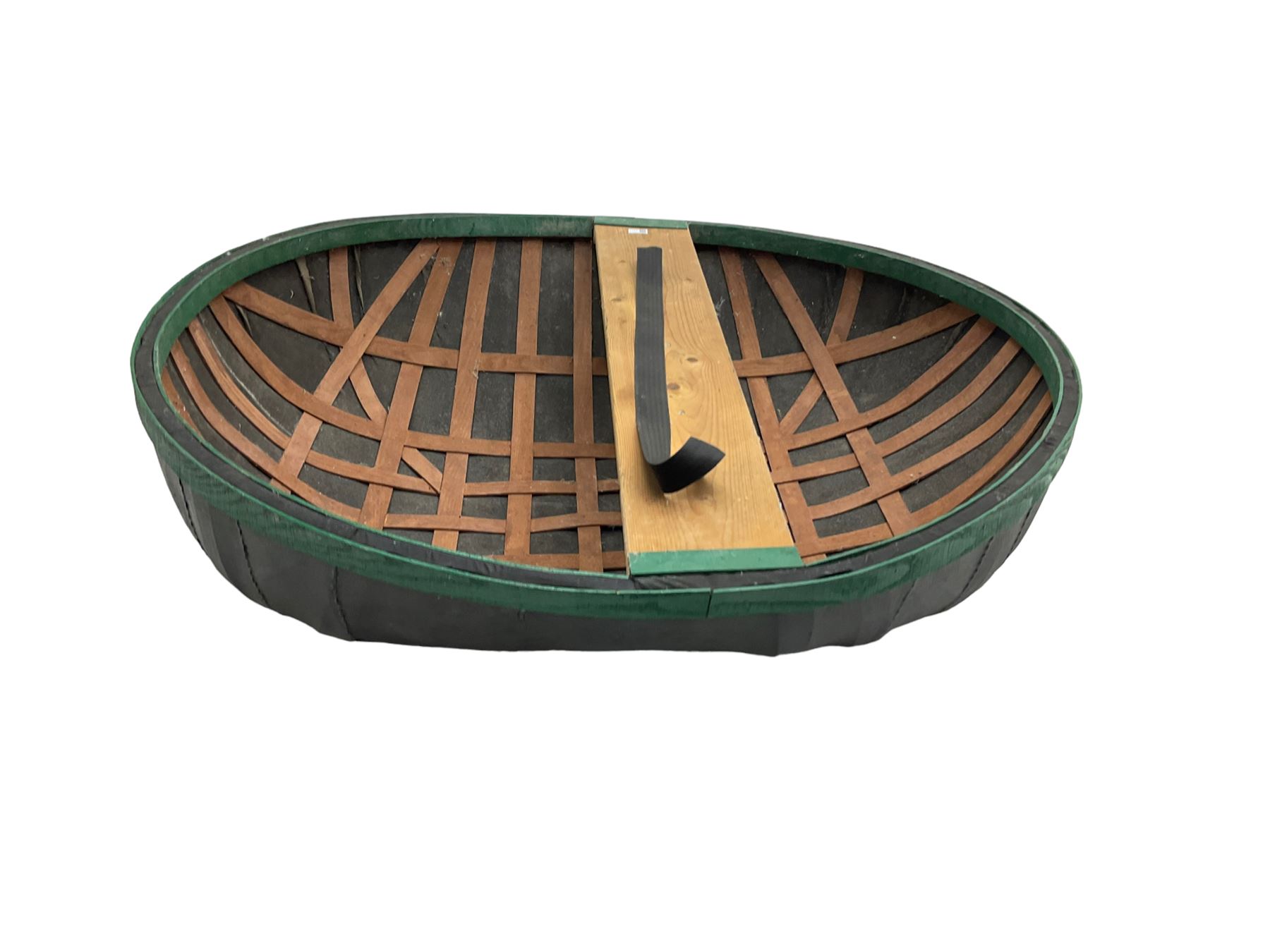 Coracle boat, comprised of woven planks and waterproof covering with single plank seat and strap