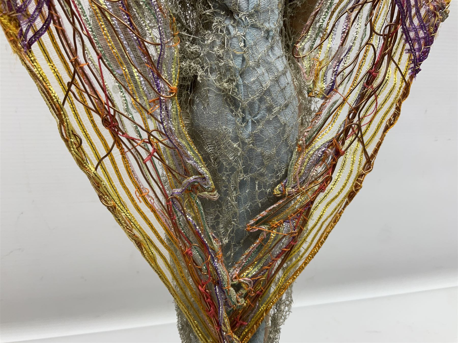 Anna Meszaros Hungary - hand made needlework figurine of an Angel with metallic lace full length dress and open threadwork wings; on moulded base H45cm Auctioneer's Note: Anna Meszaros came to England from her native Hungary in 1959 to marry an English businessman she met while demonstrating her art at the 1958 Brussels Exhibition. Shortly before she left for England she was awarded the title of Folk Artist Master by the Hungarian Government. Anna was a gifted painter of mainly portraits and sculptress before starting to make her figurines which are completely hand made and unique, each with a character and expression of its own. The hands, feet and face are sculptured by layering the material and pulling the features into place with needle and thread. She died in Hull in 1998.