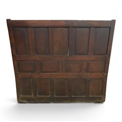 18th century oak high-back settle or hall bench, the panelled back and arm terminals over a hinged box seat, panelled front on short stile feet
