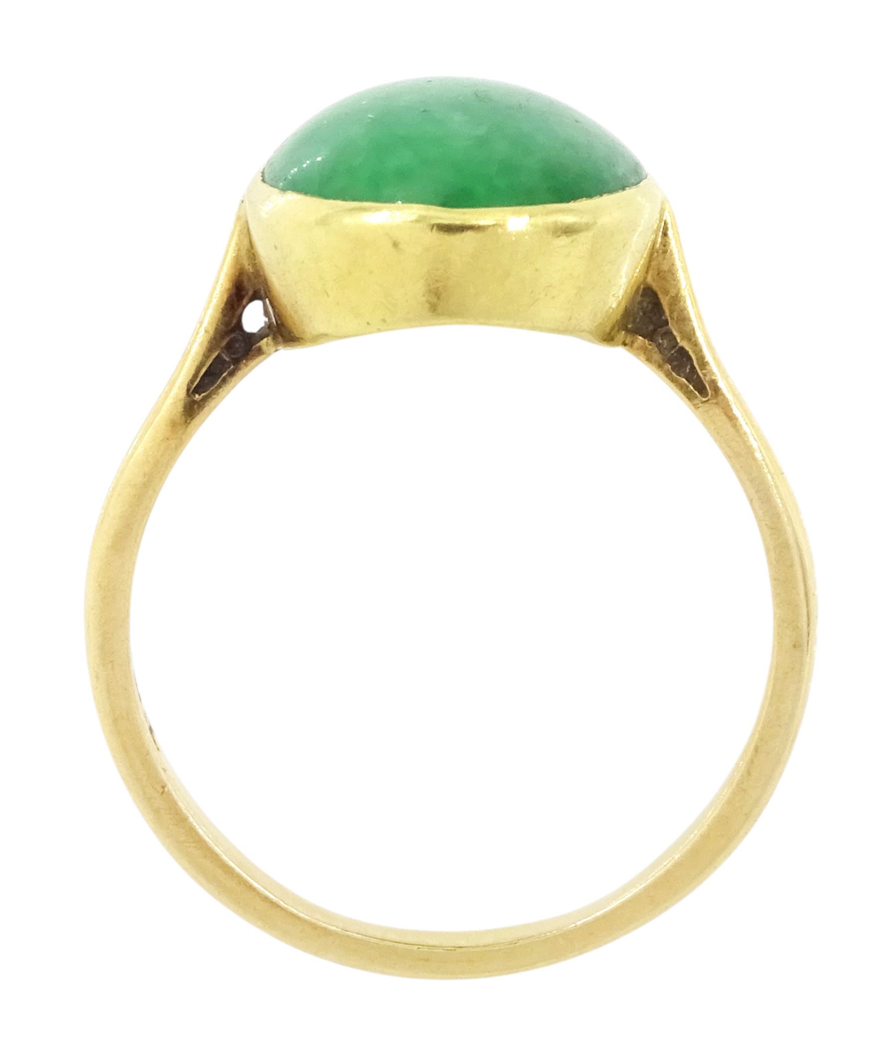 Early - mid 20th century gold jade ring, bezel set with a single oval cabochon jade of approx 4.10 carat, stamped 18ct