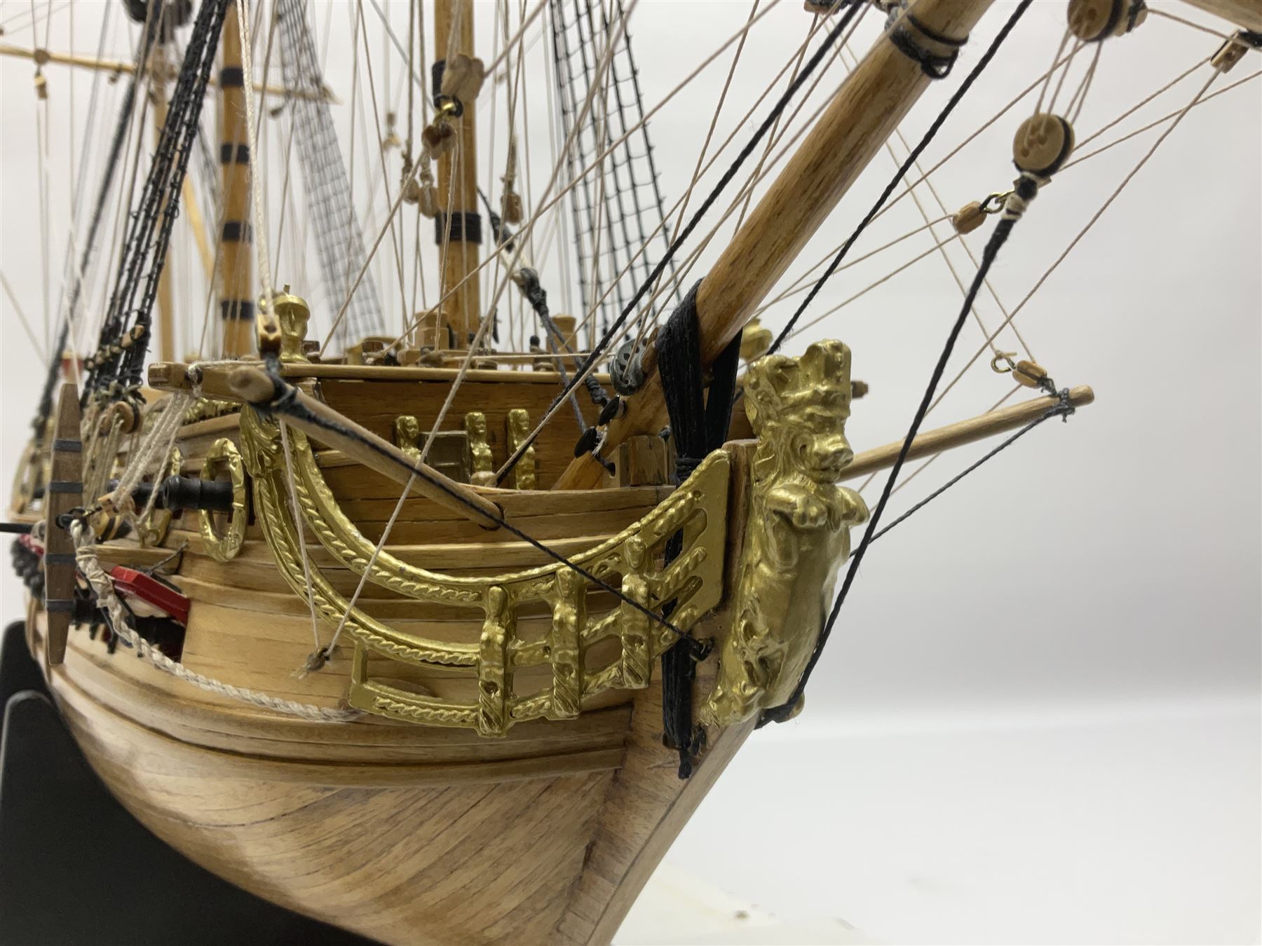 Wooden kit built model of HMS Neptune, 1:90 scale, with detailed rigging to three masts and a row of cannons to either side, upon ebonised wooden base, including stand H71cm