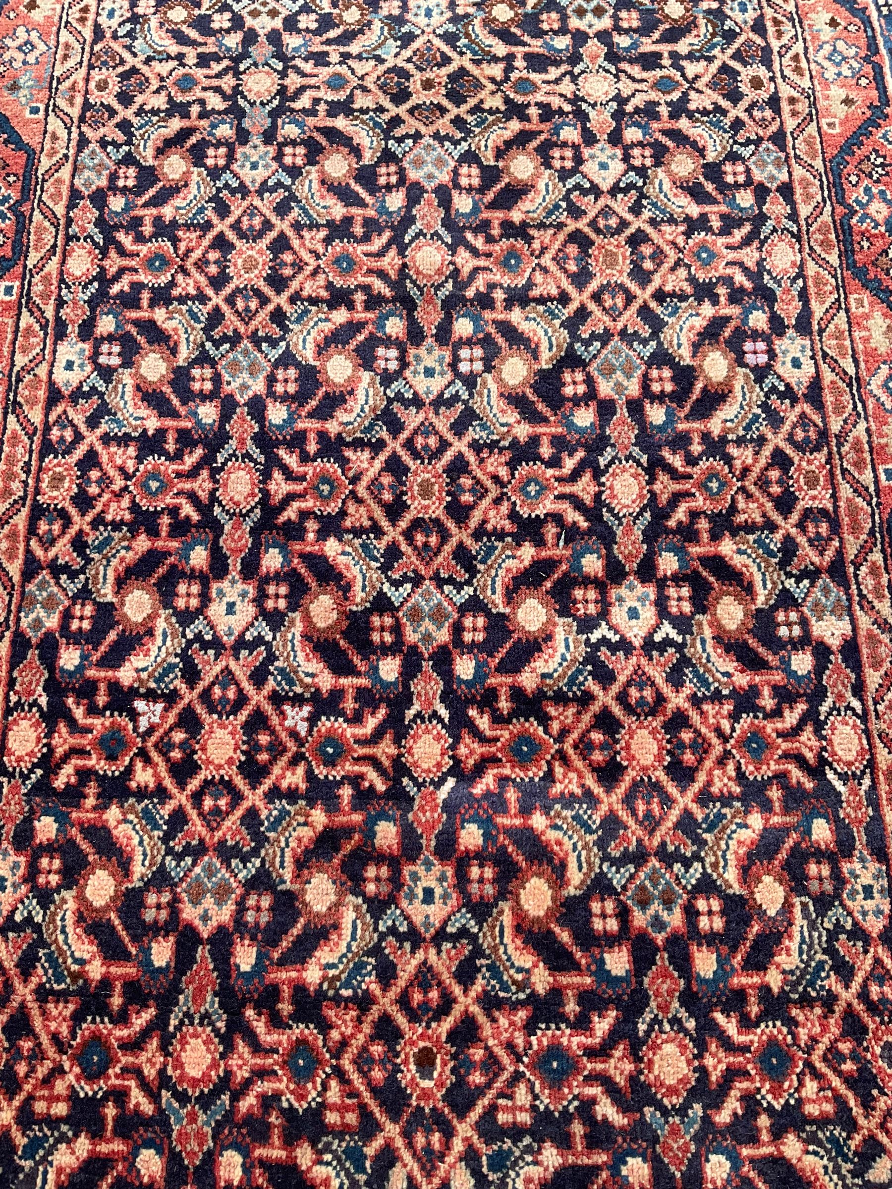 North West Persian Mahal indigo ground runner rug, the field decorated with all-over crimson Herati motifs, the guarded border with trailing geometric designs