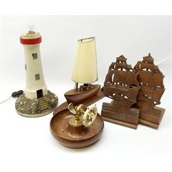 A mahogany table lamp in the form of a ship, overall H27.5cm, a further table lamp modelled as a lighthouse, H34cm, pair of teak plaques carved as ships, one with plaque detailed 'From the teak of HMS Queen Elizabeth Dardanelles 1915 Earl Beatty's Flagship Grand Fleet 1917', and a mahogany bowl surmounted with a central ships wheel. 