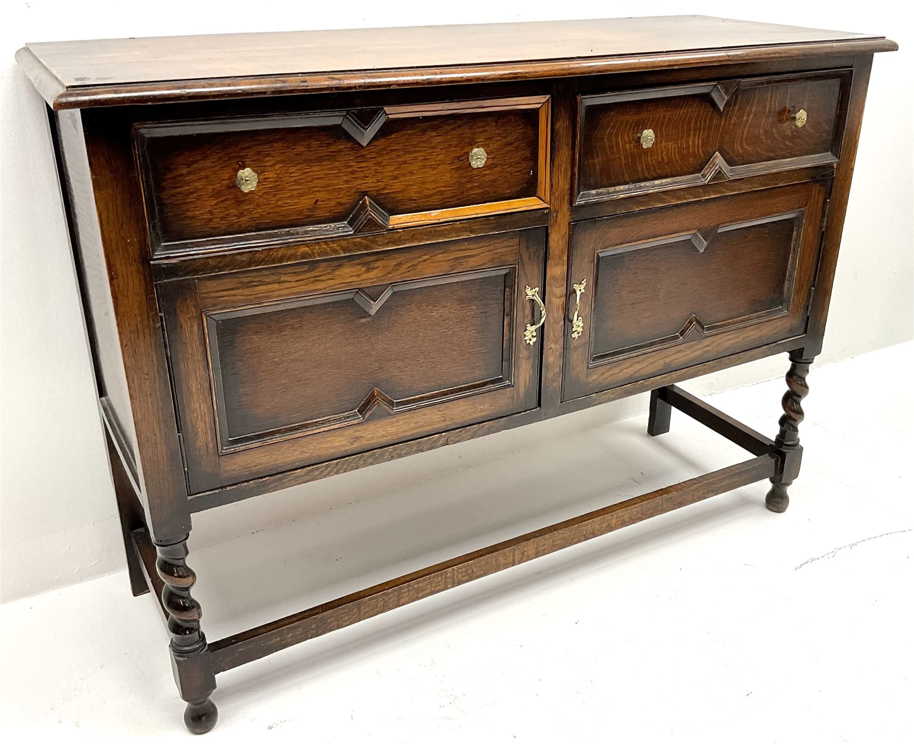  Jacobean style oak sideboard, two drawers above two cupboards, barley twist supports joined by stretchers 