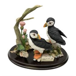 Country Artists figure group Puffin Pair with Thistles model number 02536 L19cm, Table lamp of baluster form, decorated with blossoming flowers on a red ground, upon a wooden base, with a tasselled shade, together with a lined wicker basket with hinged lid, and a collection of reference books regarding  the royal family, lamp H60cm , Table lamp of baluster form, decorated in the Oriental style with blossoming flowers and figures in a mountain scene, upon a wooden base, H54cm, and Capodimonte figural table lamp modeled as a woman and baby, signed B.Merli, with a tasseled shade, H59cm