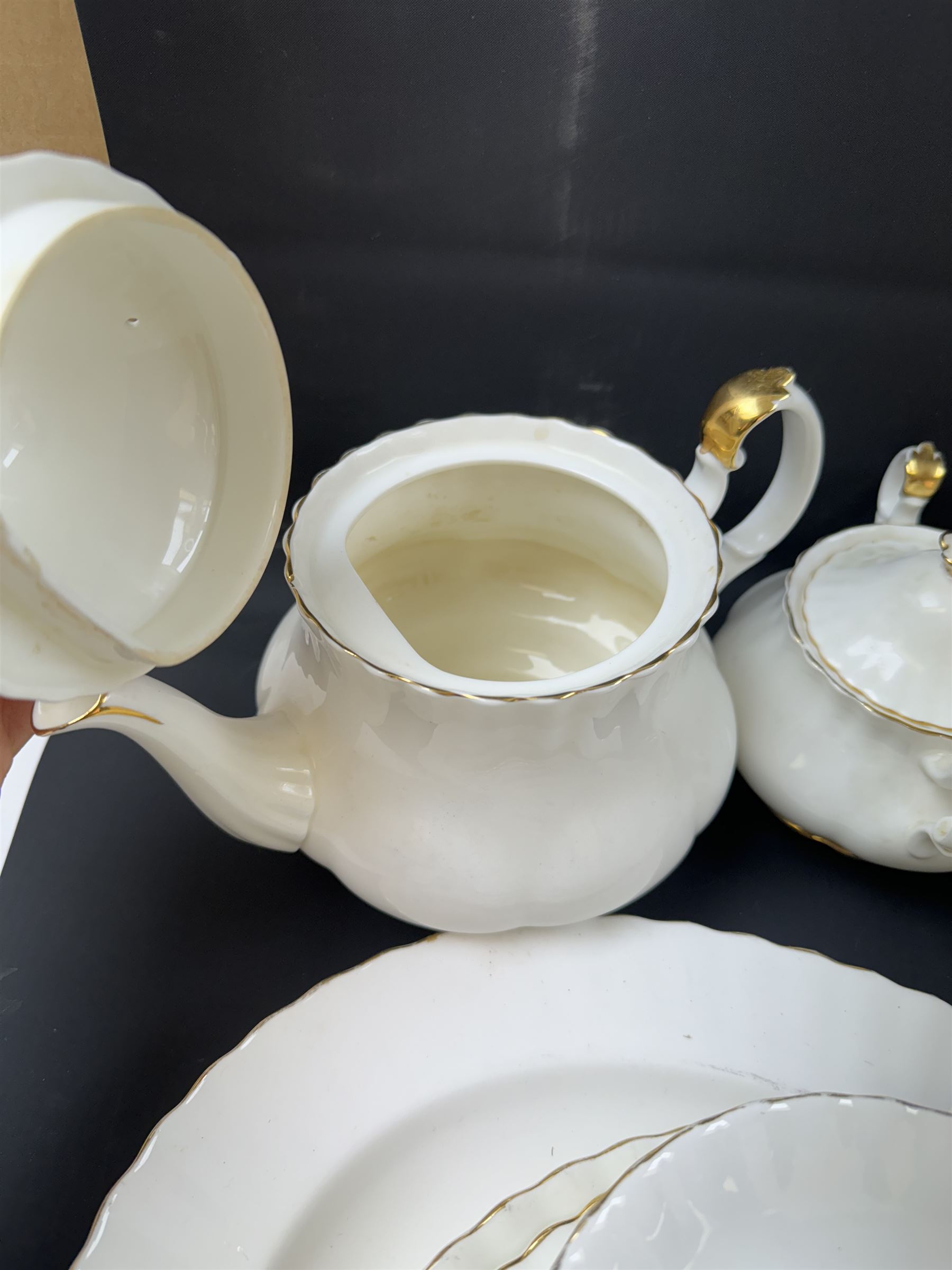Royal Albert Val D'or part tea and dinner service, including two coffee pots, two teapots, milk jug, covered sucrier etc together with matching items 
