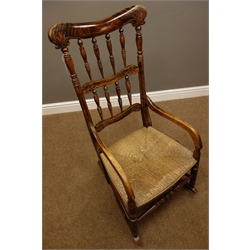  Late Victorian rosewood scumbled beech rocking armchair, spindle back with carved detail, rush seat  