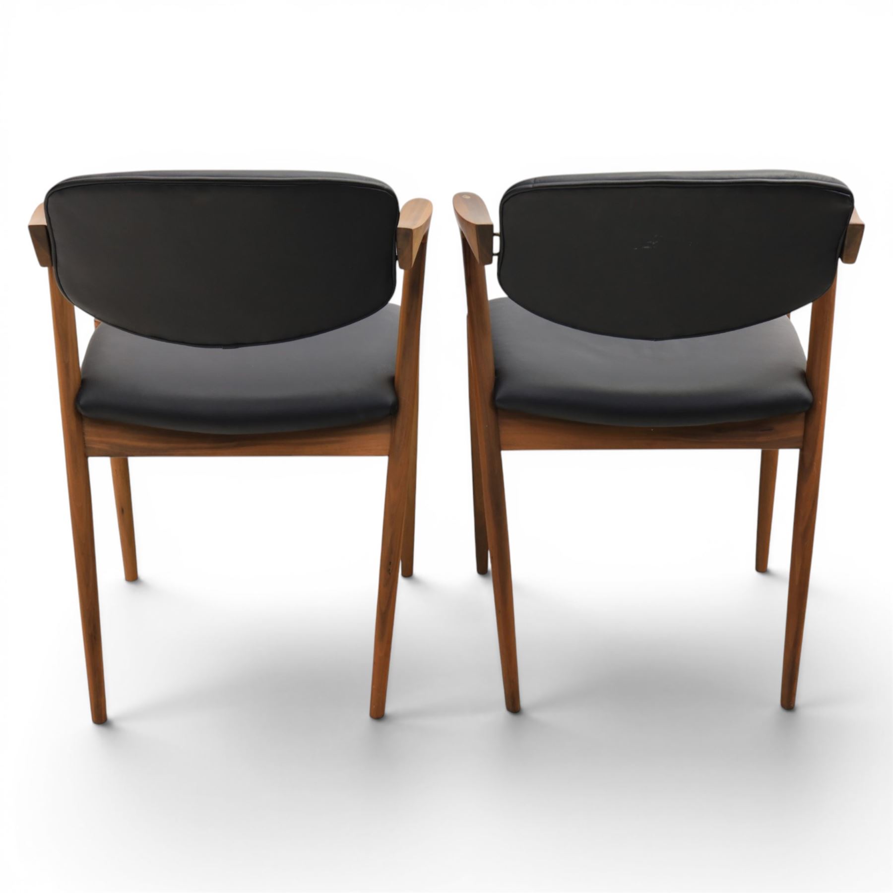 Kai Kristiansen (Danish c.1929-2022) - Pair of mid-20th century teak elbow chairs upholstered in black leatherette