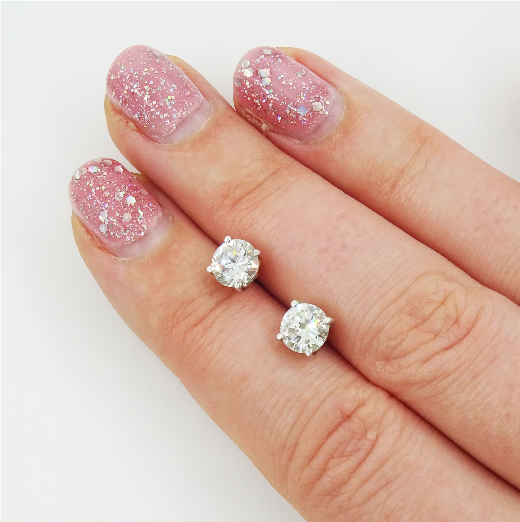 Pair of 18ct white gold round brilliant cut diamond stud earrings, total diamond weight approx 1.20 carat