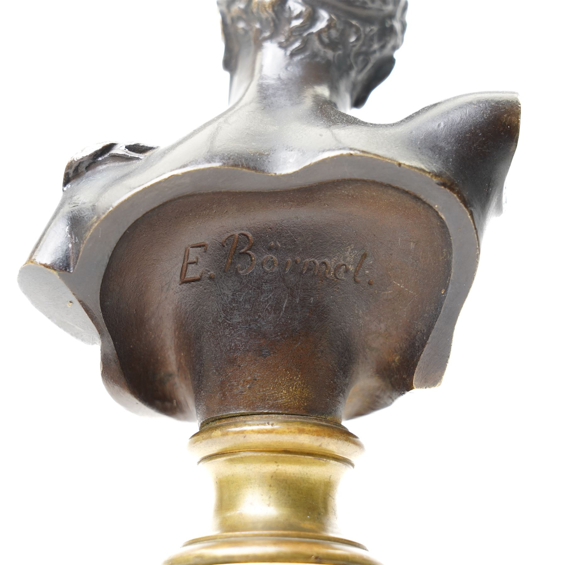 After the Antique - Eugen Börmel (Bormel) (German 1858-1932): a patinated bronze bust of Hermes, the youthful messenger of the gods modelled with idealised features and curling hair, the truncated torso mounted on a classical brass socle and cylindrical marble pedestal, signed to the reverse, H25.5cm