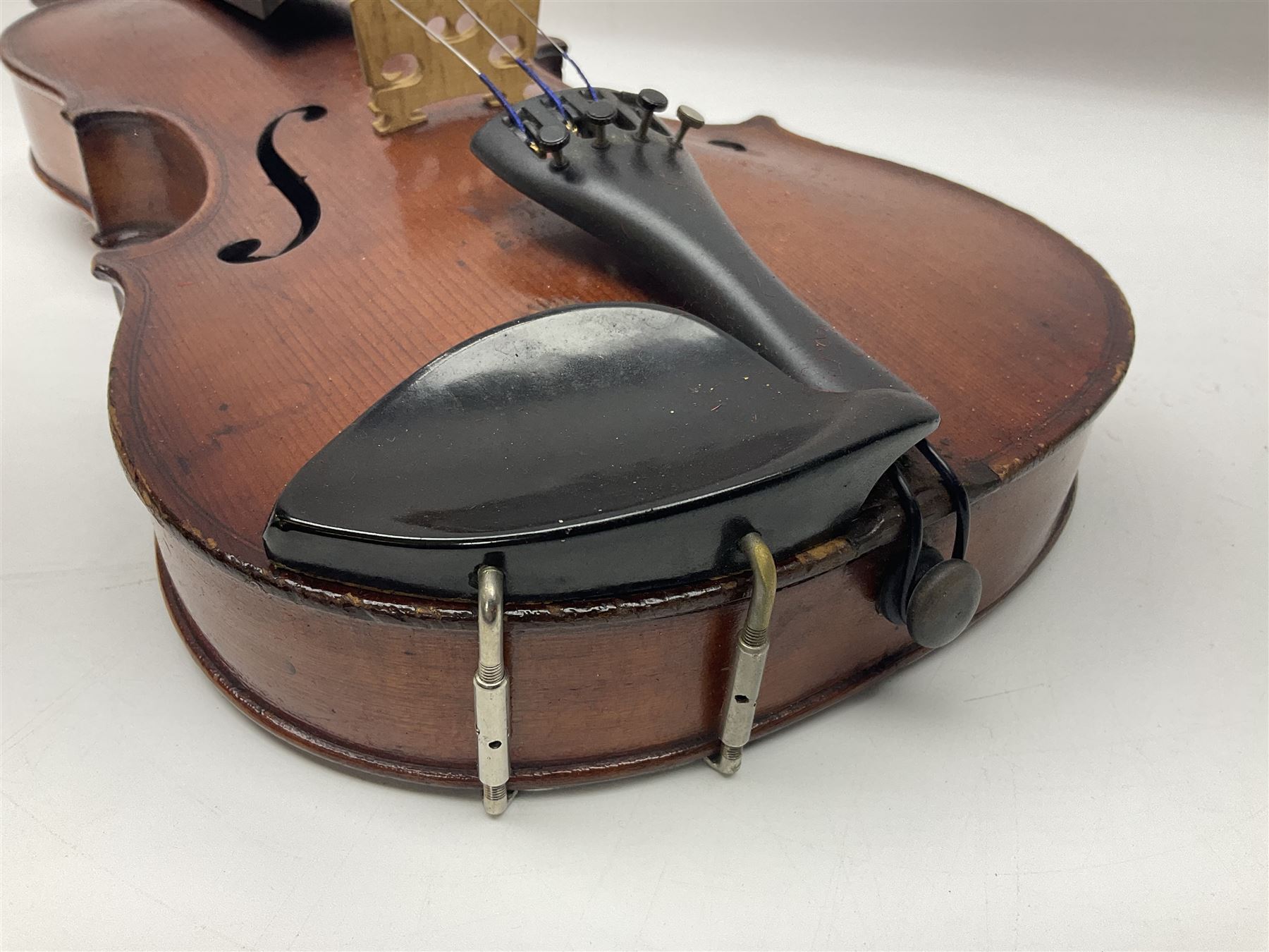 German violin c1890 with 36cm two-piece maple back and ribs and spruce top; bears label 'Antonius Stradivarius Cremona Faciebat Anno 1729' L59.5cm overall; in ebonised wooden 'coffin' case; and two German violins c1890 for completion - one bearing a Stradivarius label, the other a Ruggeri label; both in carrying cases (3)