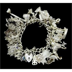Silver curb link bracelet, with heart locket clasp and thirty-five silver charms including elephant, crab, poodle, butterfly, lobster pot, fish, dinosaur, platypus and hedgehog