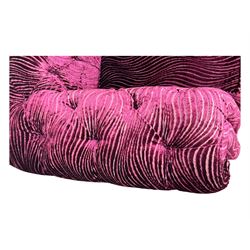 Contemporary Chesterfield design two-seat sofa, upholstered in fuchsia crushed velvet with a ribbed and tufted design, the rolled arms and deep-buttoned backrest raised on square block supports