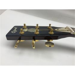 Ozark metal cased resonator guitar with all over chased foliate decoration to the polished finish and mother-of-pearl inlay to the fretboard L100cm; in Stagg hard carrying case