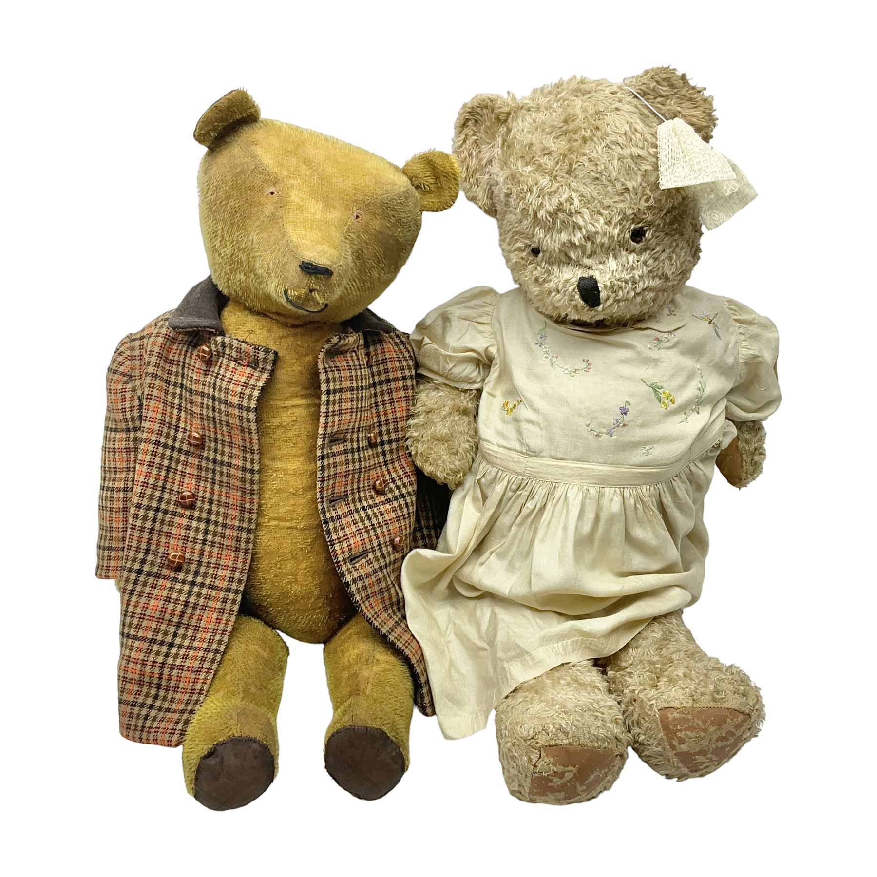 Two early 20th century straw filled jointed teddy bears, first example wearing a tweed jacket bearing Geoffrey Saville label, with leather padded paws and ears, horizontally stitched nose and humpback; second example with applied eyes, vertically stitched nose and faux leather paw pads, both with growler mechanisms, tallest H74cm 