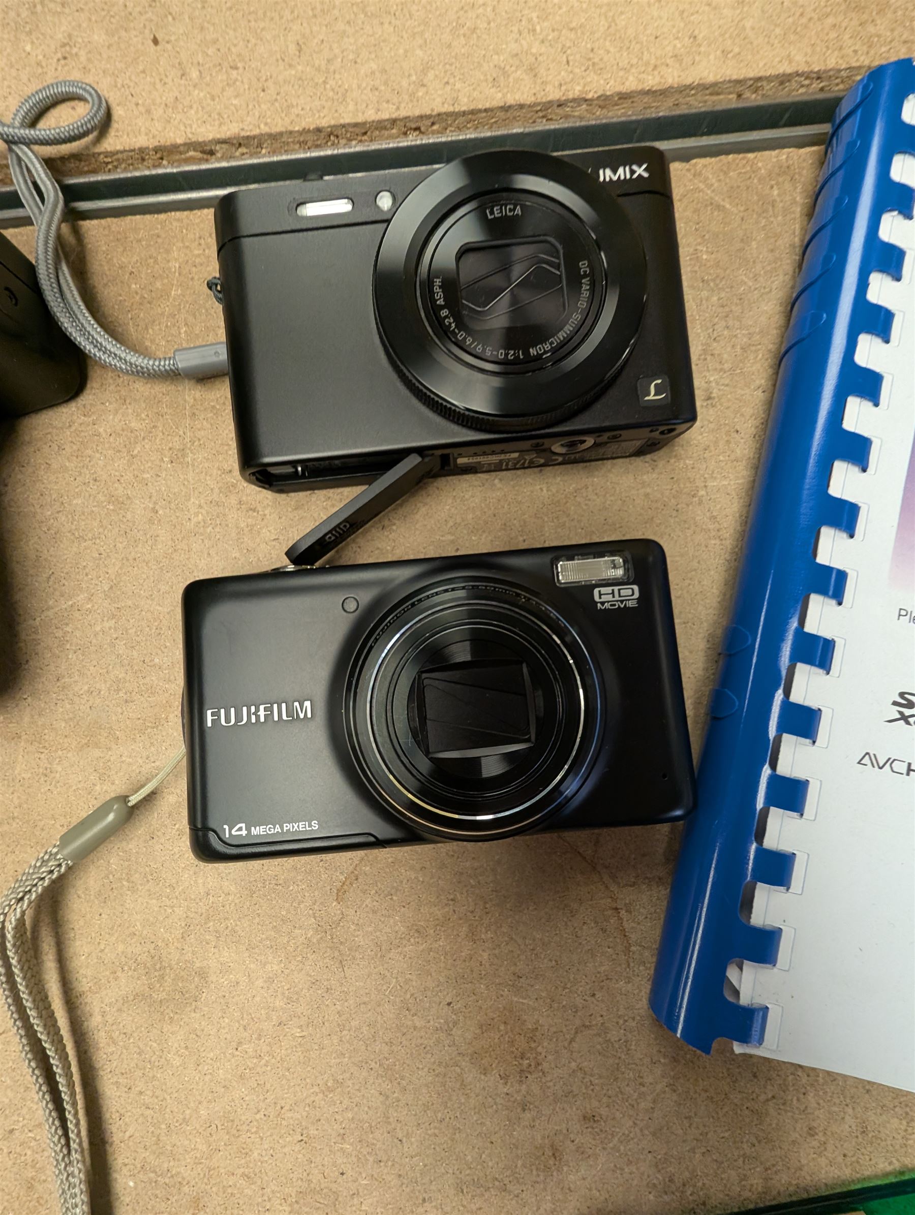 Panasonic Lumix DMC-LF1 digital camera, with charger and instruction booklet, together with a Minolta Dynax 5000i SLR camera body with a Minolta AF Zoom 35-80mm 1:4 (22)-5.6 lens, and a Fujifilm Finepix T digital camera
