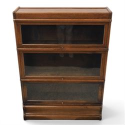 Globe Wernicke - early 20th century oak stacking bookcase, three tiers, lift up glazed doors raised on a plinth base