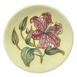 Moorcroft Tiger Lily pattern plate on a yellow ground, with painted and impressed mark beneath, D26cm