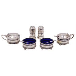 Early 20th century silver six piece cruet set, comprising two open salts, two mustard pots with covers, and two peppers, each with vertical pierced bands, and blue glass liners, hallmarked Gorham Manufacturing Co, Birmingham 1912 and 1913, and three silver cruet spoons, hallmarked Joseph Rodgers & Sons, Sheffield 1912 and 1913, contained within a fitted case, approximate total silver weight 4.74 ozt (147.7 grams)