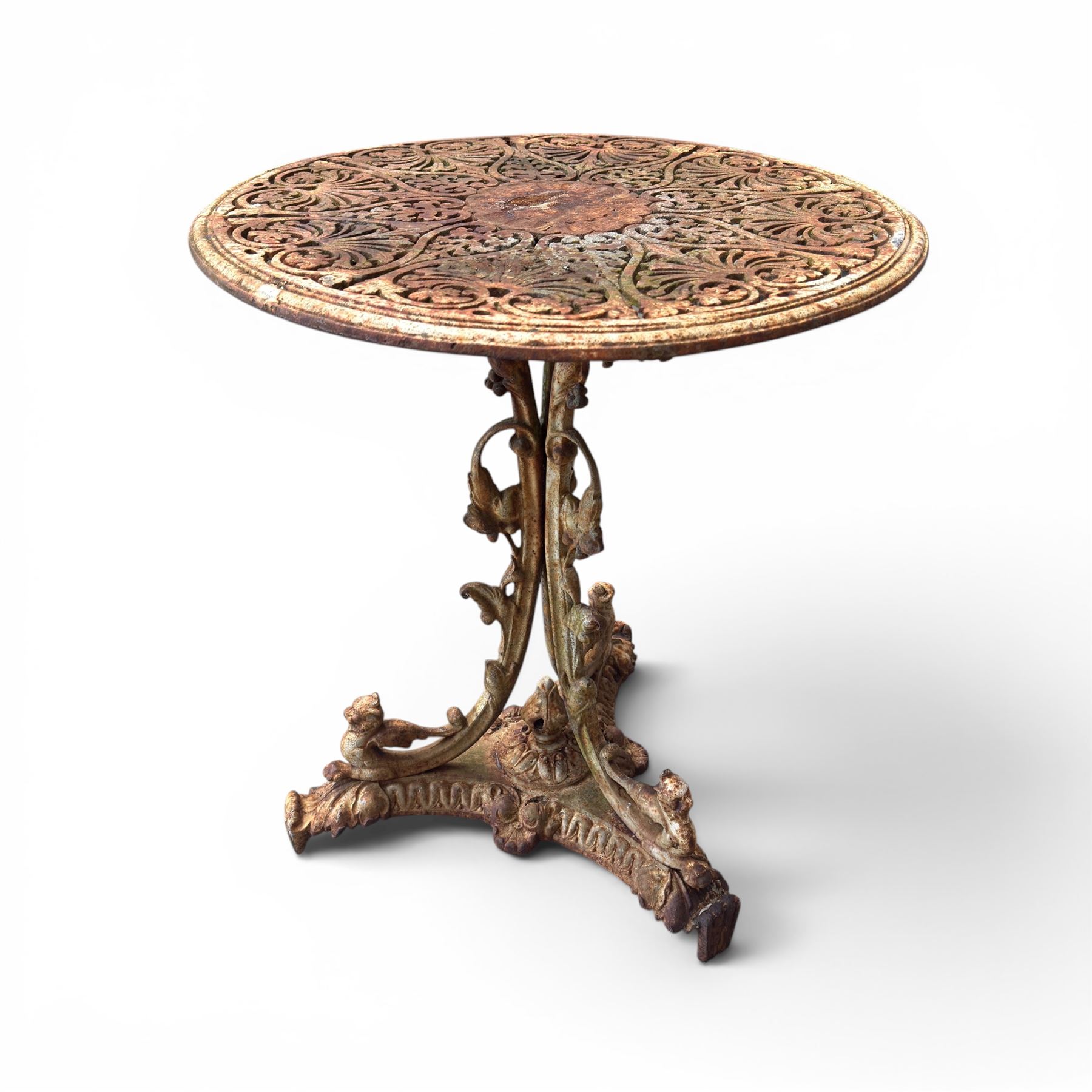 Victorian cast iron garden table, circular pierced top with foliate and scroll decoration, raised on an ornate tripod base with natural weathered paint finish.