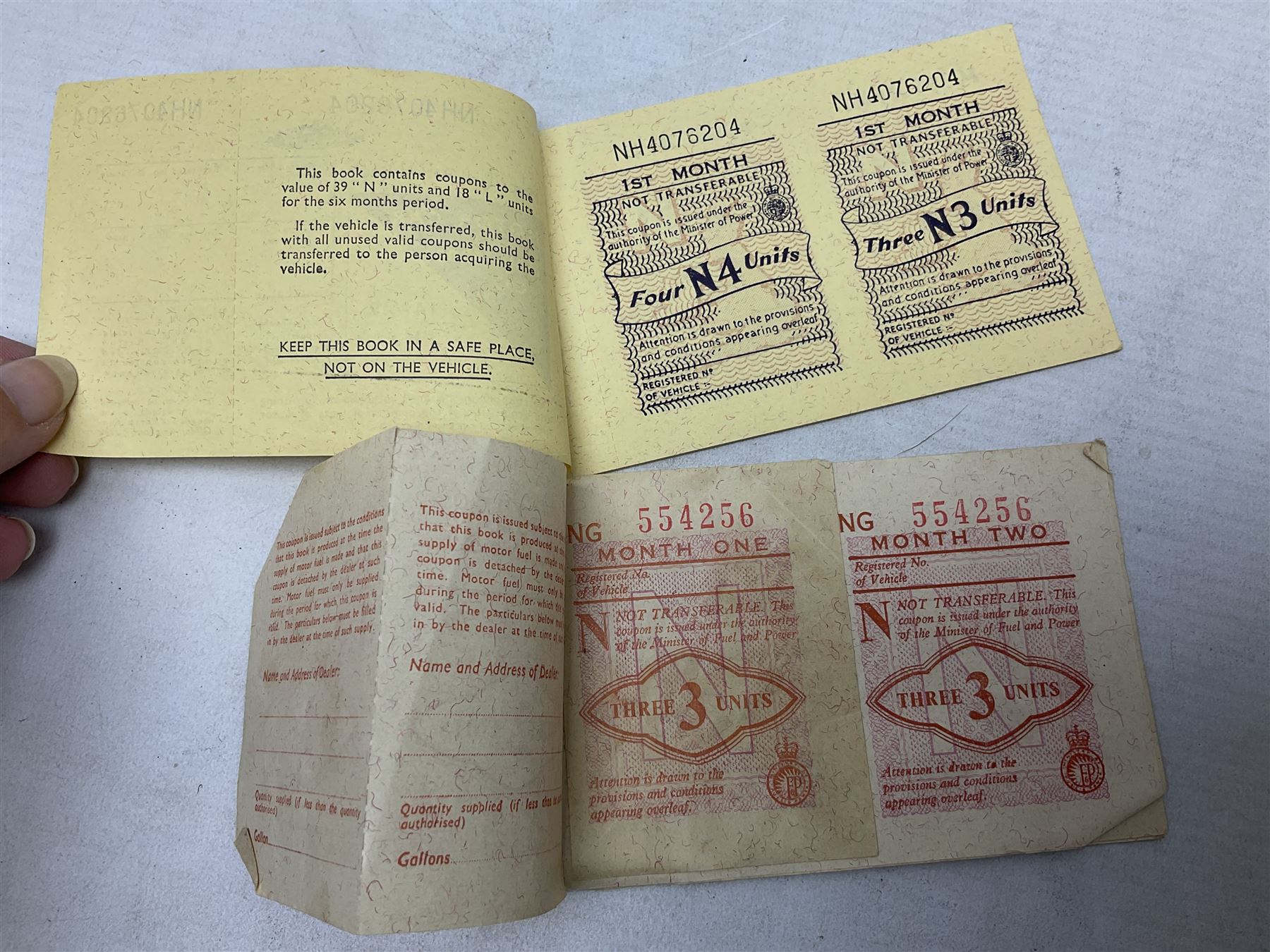 Gold plated leaping Jaguar car mascot, no.7'24265'3WB L12.5cm; three AA car badges and Veteran Motorists car badge; and quantity of 1950s fuel and general ration books