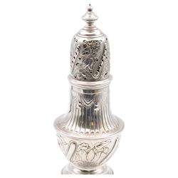 Victorian silver sugar caster, of typical waisted form with engraved and embossed floral and berry decoration, the removable pierced cover with urn finial, upon a circular stepped foot, hallmarked Charles Edwards, London 1884, H20.5cm