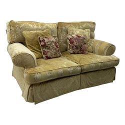 Contemporary two-seat sofa, upholstered in damask fabric with a pale gold floral pattern, rolled arms with covers, loose back and seat cushions, on matching skirted base with concealed castors