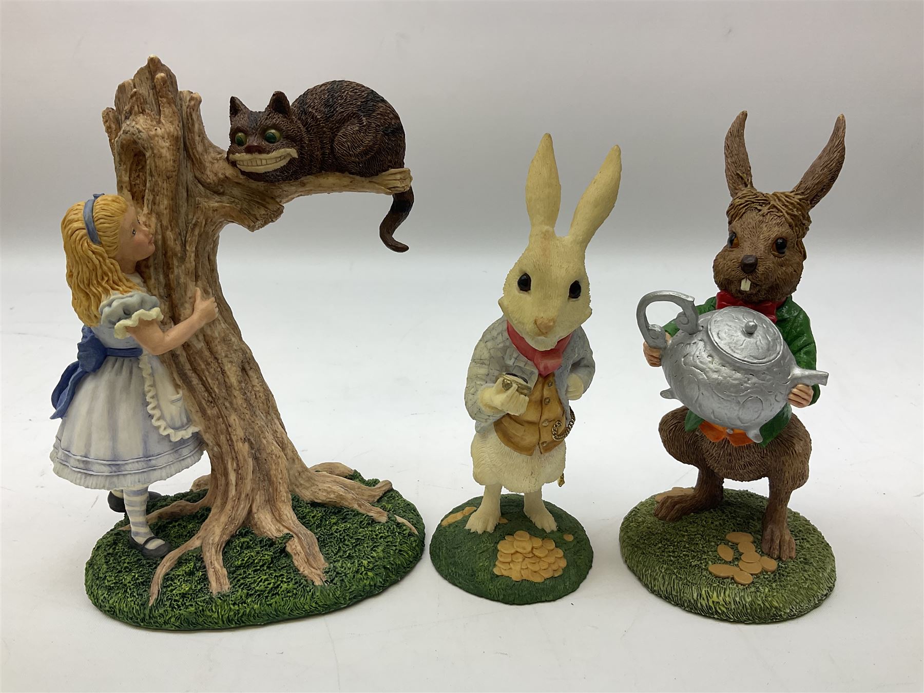 Goebel Alice in Wonderland figures, comprising Alice and Cat, White Rabbit, Queen of Hearts, March Hare, Tweedle Dee and the Mock Turtle, largest H18cm