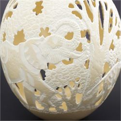 Ostrich egg with pierced decoration, depicting elephants in a forest, H16cm