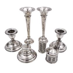 Group of early 20th century silver, to include a pair of specimen vases, of plain trumpet form, upon knopped stem and filled stepped circular foot, hallmarked J & R Griffin, Chester 1915, pair of silver mounted dwarf candlesticks, hallmarked J & R Griffin, Chester 1909, small silver mounted capstan inkwell with glass insert, hallmarked Chester 1909, maker's mark worn and indistinct, silver pepper, with pierced decoration, hallmarked S Blanckensee & Son Ltd, Birmingham 1909 and a similar mustard pot and cover, hallmarked S Blanckensee & Son Ltd, Chester 1909, both with blue glass liners