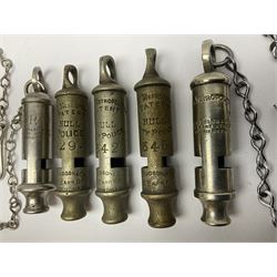 Three Hull City Police 'Metropolitan' whistles by J. Hudson 13 Barr Street Birminham, each with impressed collar number; another 'Metropolitan' police whistle with chain; and an ARP whistle by Hudson & Co with chain (5)