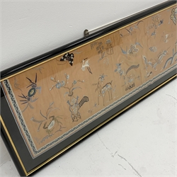 A large Chinese silk panel embroidered on orange silk with central Pagoda amongst Fish, Dragon, Cockerels, precious object and flowers, within a glazed frame, L75cm x 33cm 