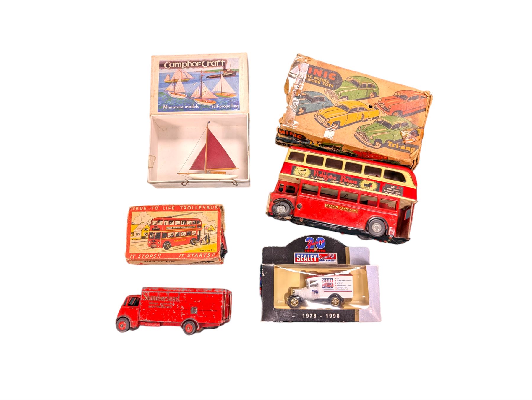 Small collection of model vehicles, including tin-plate trolley bus, Dinky Guy lorry, Triang Pedigree Prams bus, etc