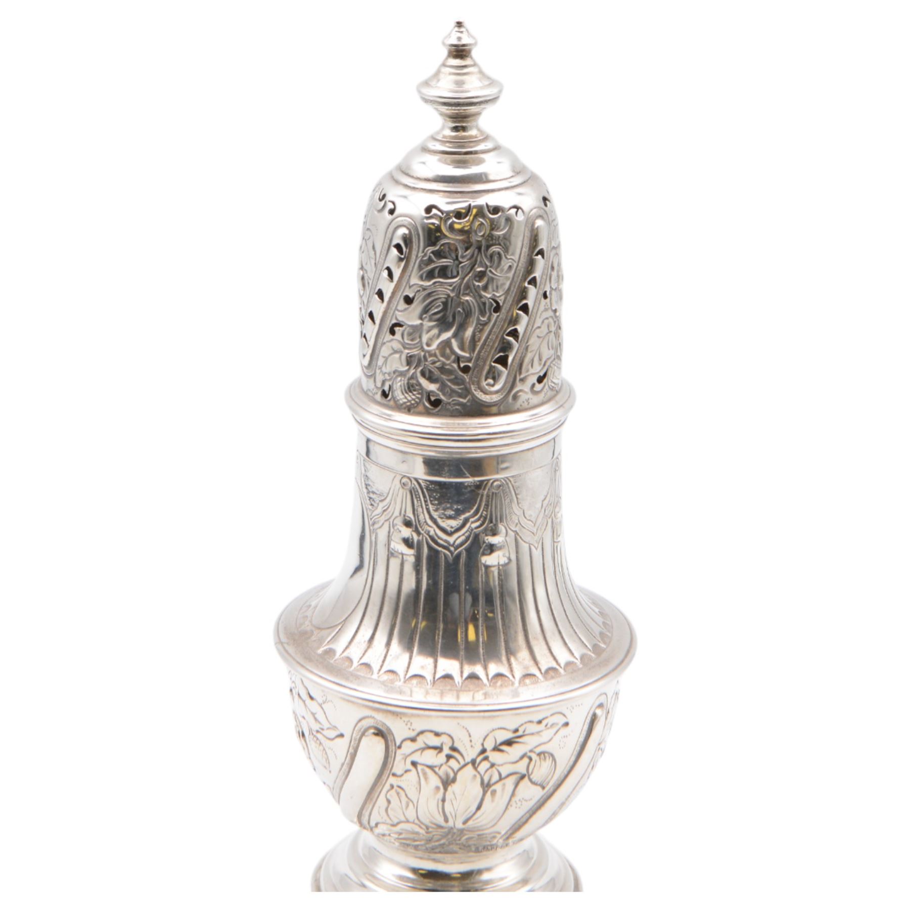 Victorian silver sugar caster, of typical waisted form with engraved and embossed floral and berry decoration, the removable pierced cover with urn finial, upon a circular stepped foot, hallmarked Charles Edwards, London 1884, H20.5cm