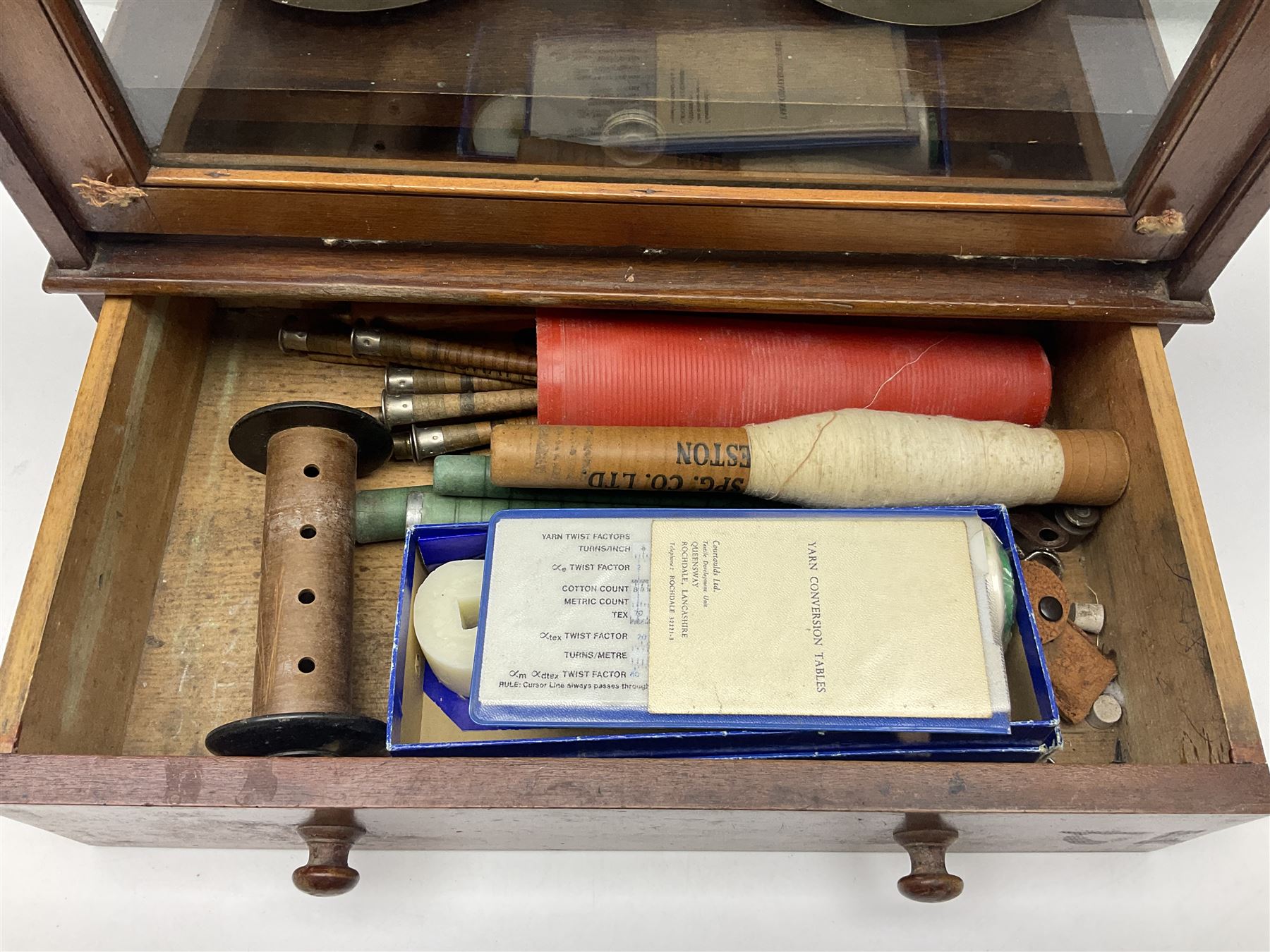 Collection of textile equipment, comprising, Goodbrand & Co. mahogany and brass yarn tester, Negretti & Zambra barograph and two sets of precision scales