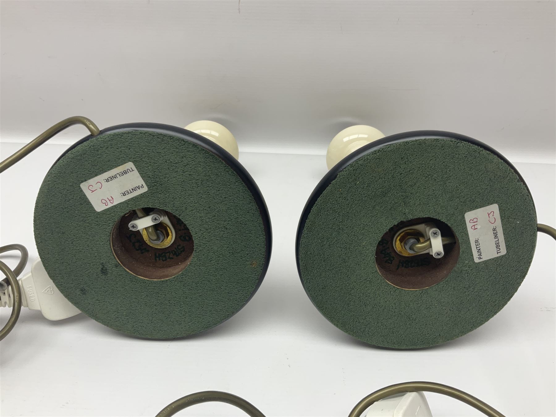 Pair of Moorcroft table lamps of candlestick form in magnolia pattern, with Moorcroft shades, H50cm 
