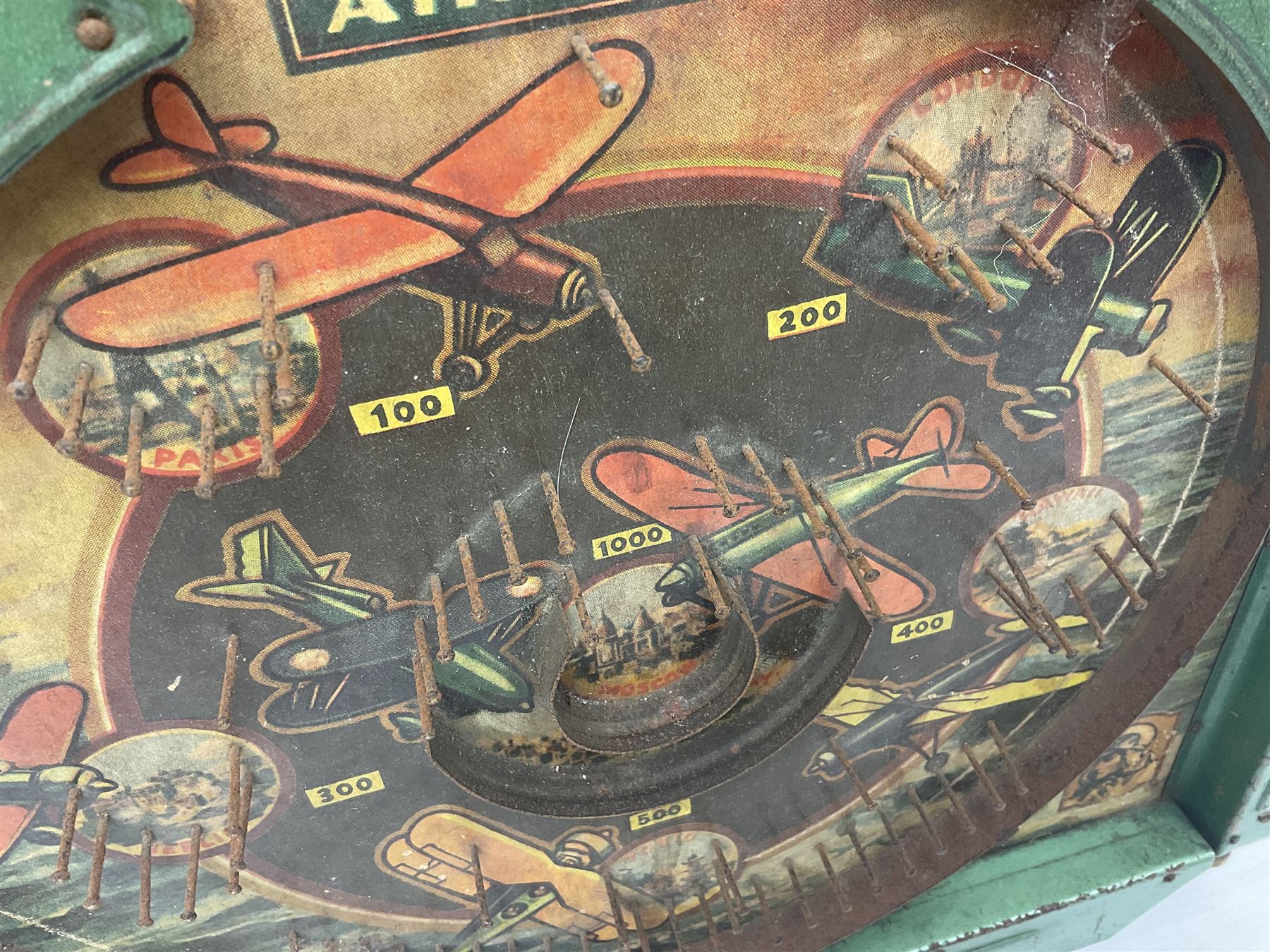 1934 Lindstrom's 'Airways' tin-plate bagatelle game by Lindstrom Tool and Toy Company Bridgeport Conn., the decorative bagatelle board depicting Lindstrom's epic airway routes; with wooden peg and quantity of balls H61cm