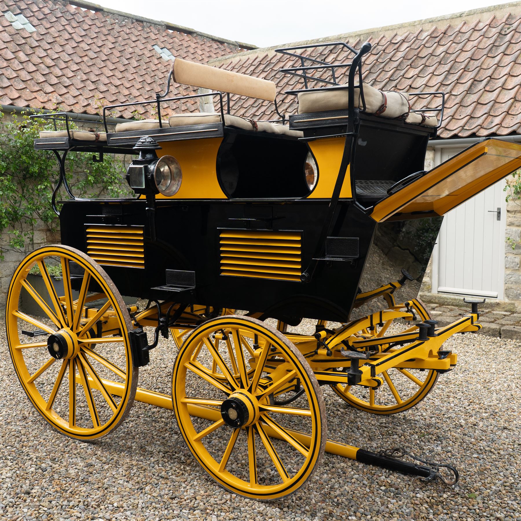 Roof Seat Break by Shanks of London

A roof seat break by Shanks of London built on a perch in black and yellow livery, the body fitted with an elevated driver's box seat, elevated rear groom's seat and central passenger compartment. The carriage is mounted on wooden spoked wheels with leaf spring suspension and is equipped with louvred underbody storage compartments, carriage lamp brackets (lamps next lot), folding access steps and a pole for driving with a pair or team of horses. The wheel hubs are stamped 