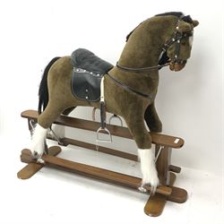 Rocking horse with leather saddle and reins on stained wooden trestle base