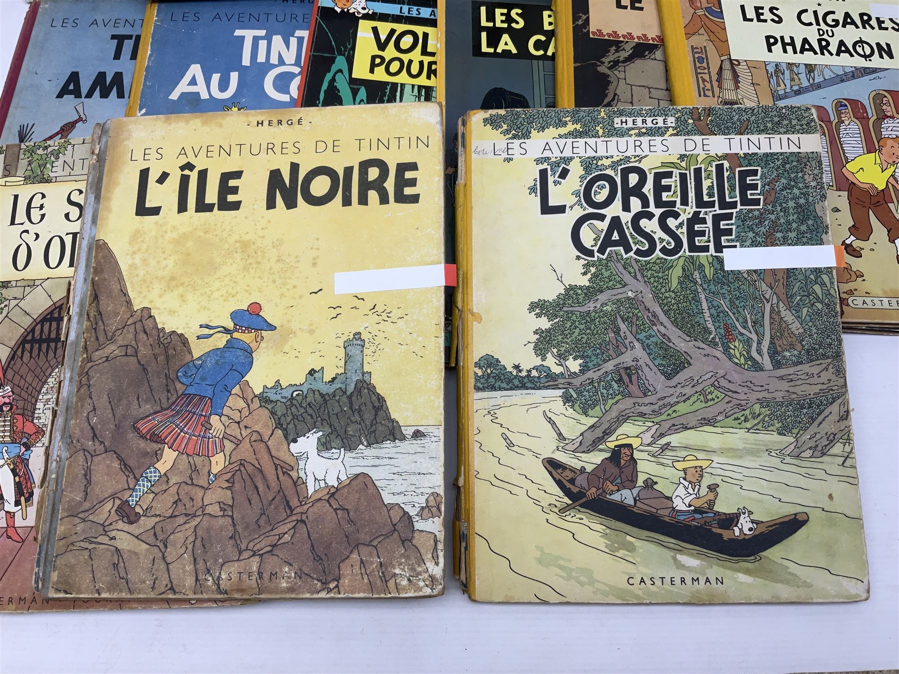 Twenty one first edition Herge, 'The Adventures of Tin Tin' books published by Casterman Bruxelles, with French text and coloured comic strip illustrations throughout; comprising Tintin Au Congo 1946, Tintin En Amerique 1946, Les Cigares du Pharaon 1955, Le Lotus Bleu 1946, L'Oreille Cassee 1943, L'ile Noire 1943, Le Sceptre d O'ttokar 1947, Le Crabe Aux Pinces D'or 1943, L'Etoile Mysterieuse 1942, Le Secret de la Licorne 1943, Le Tresors de Rackan Le Rouge 1945, Les 7 Boules de Cristal 1948, Le Temple du Soleil 1949, Au Pays de L'Or Noir 1950, Objectif Lune 1953, On a Marche sur la Lune 1954, L'Affaire Tournesol 1956, Coke en Stock 1958, Tintin au Tibet 1960, Les Bijous de la Castafiore 1963 and Vol 714 Pour Sydney 1968

