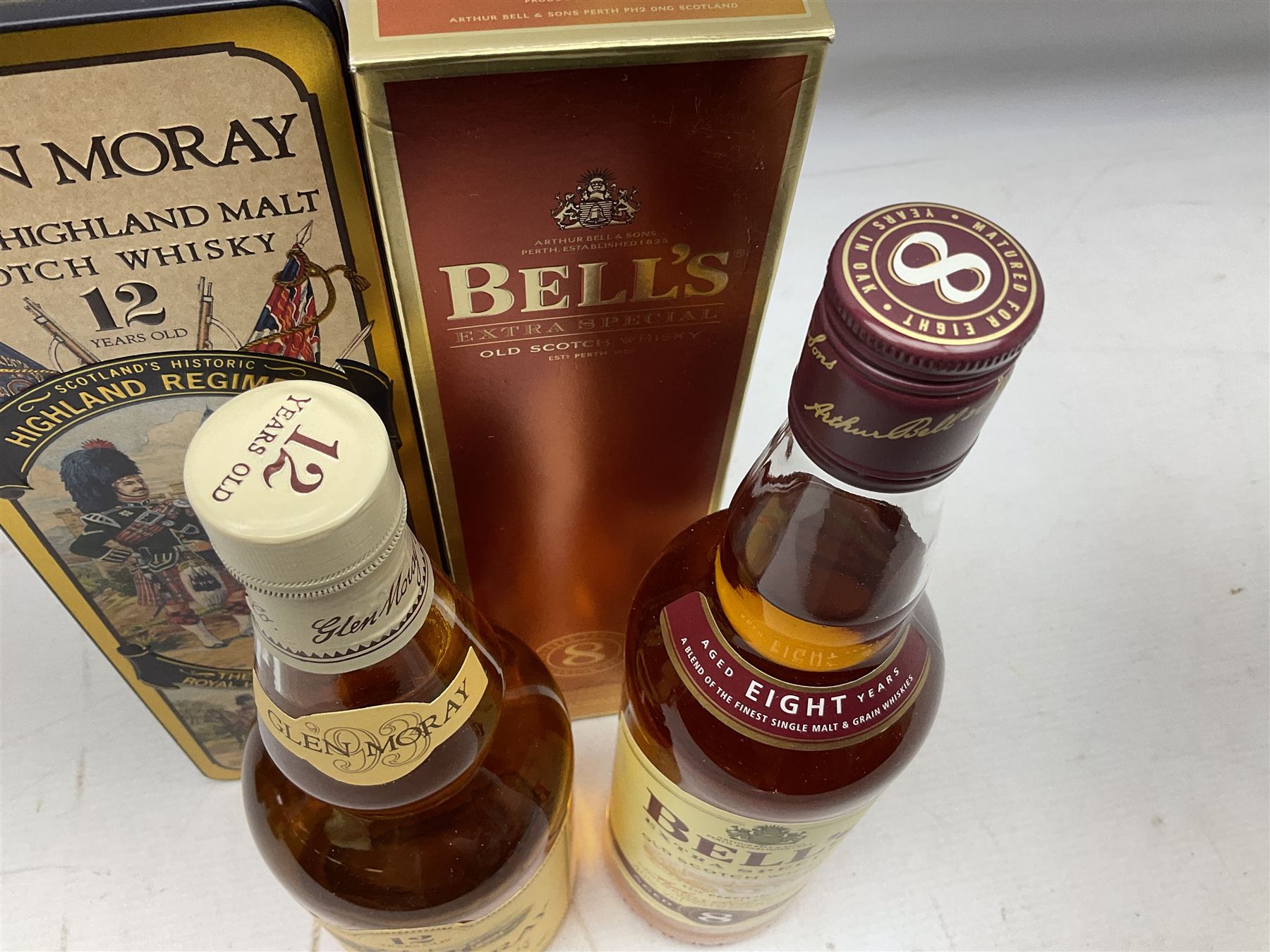 Glen Moray 12 Year Single Malt Highland Scotch Whisky, 70cl 40% vol, one bottle, in Highland Regiments The Black Watch presentation tin, Glenfiddich Pure Malt Scotch Whisky, Special Old Reserve, 70cl 40% vol, one bottle, in Clan Murray presentation tin, Bell's Extra Special Old Scotch Whisky, Aged 8 Years, 70cl 40% vol, one bottle, in box and Bell's Extra Special Old Scotch Whisky, 1l, 43% vol (4)