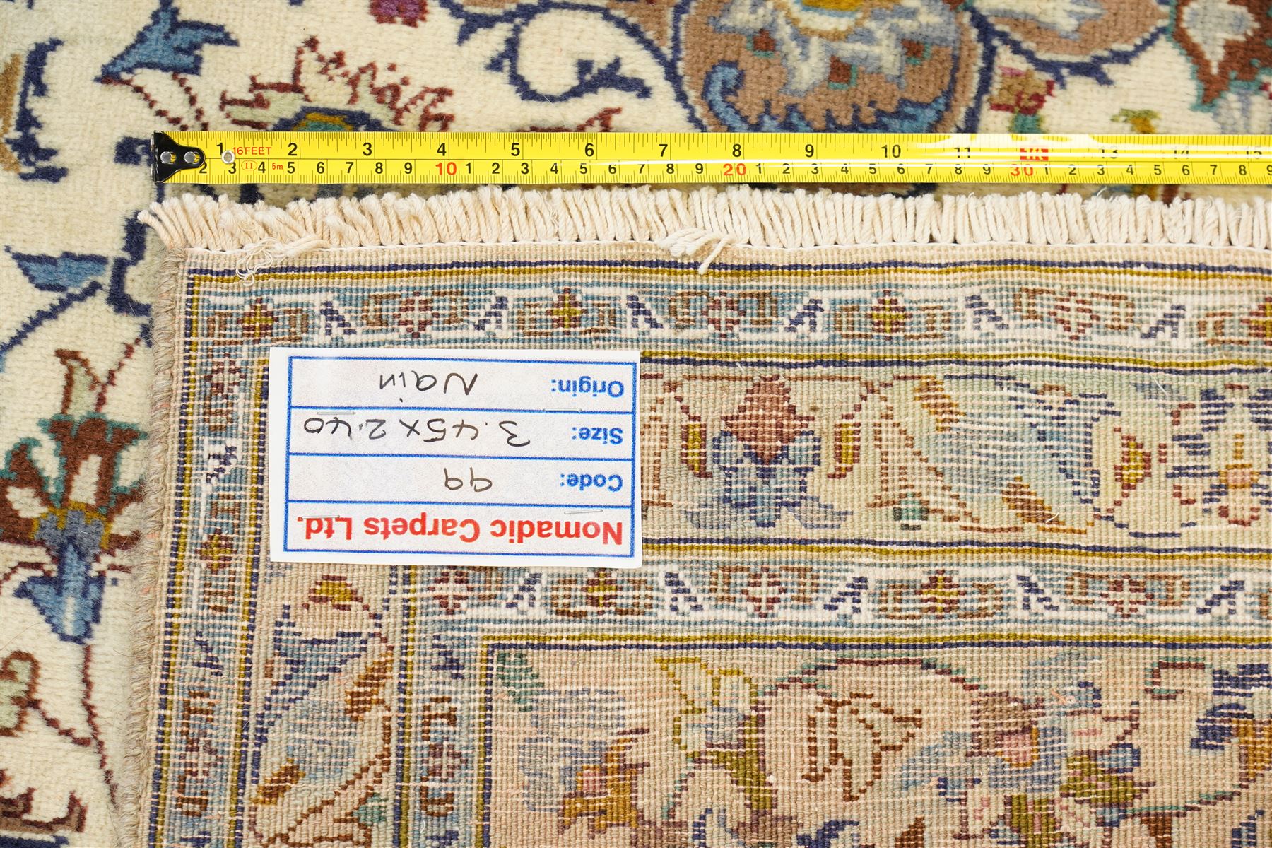 Central Persian Nain hand-knotted carpet, ivory field with central radiating medallion with pendants, issuing an all-over design of scrolling vines, palmettes, and floral sprays within confirming spandrels, framed a complimentary foliate border flanked by multiple guard stripes, with cotton fringe ends 